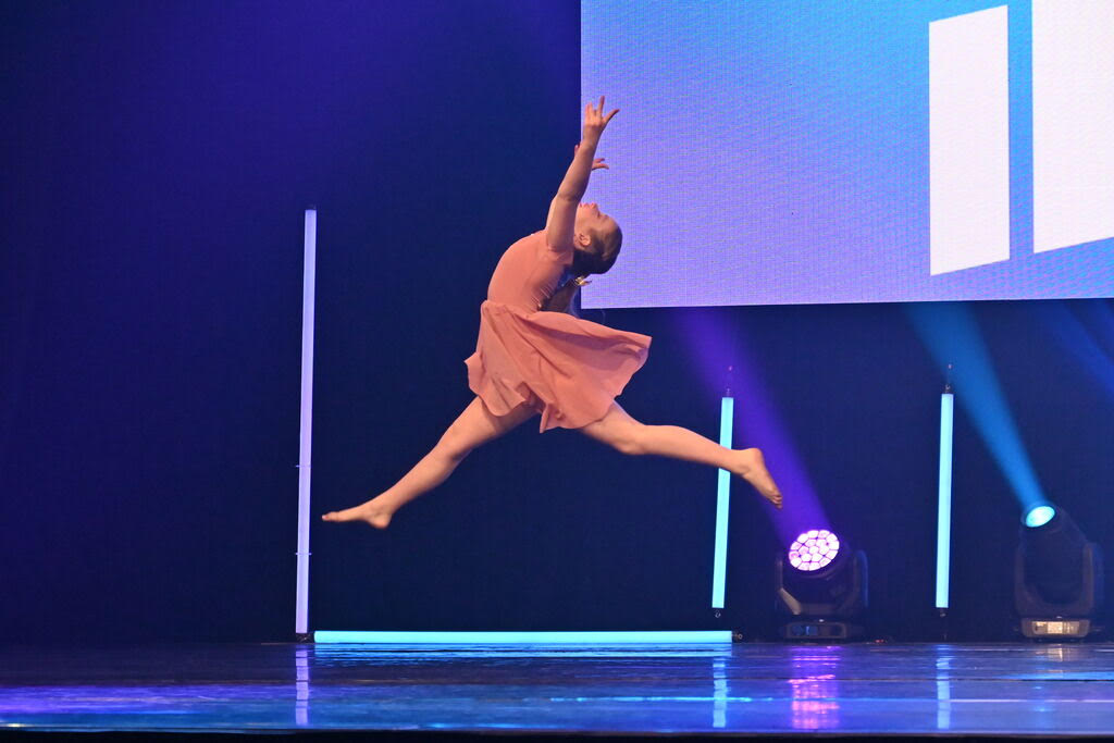 UpBeat dancer leaping on stage